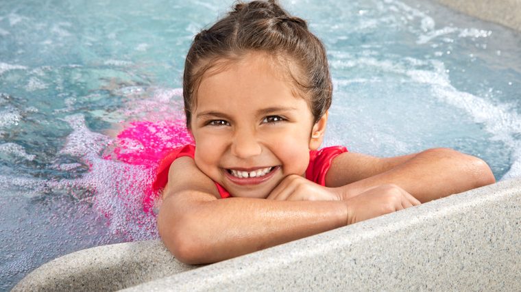 Young girl smiling in a Free Flow hot tub