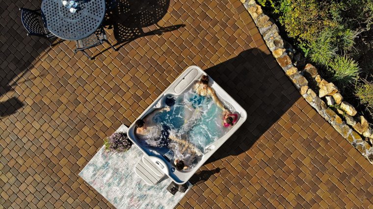 Aerial view of a Free Flow hot tub on a backyard patio