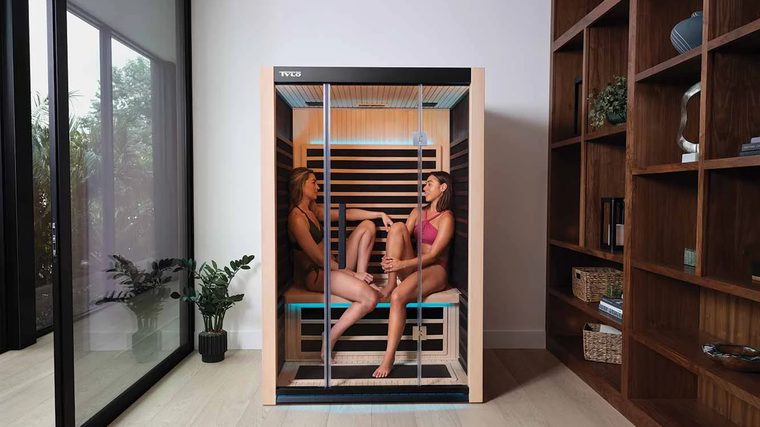 Two people relaxing in a Tylö home sauna