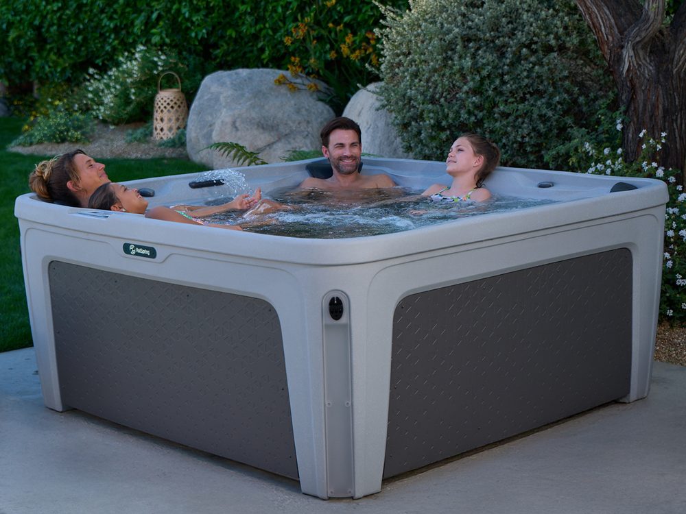 Family relaxing in a plug-and-play Hot Spring Freeflow hot tub